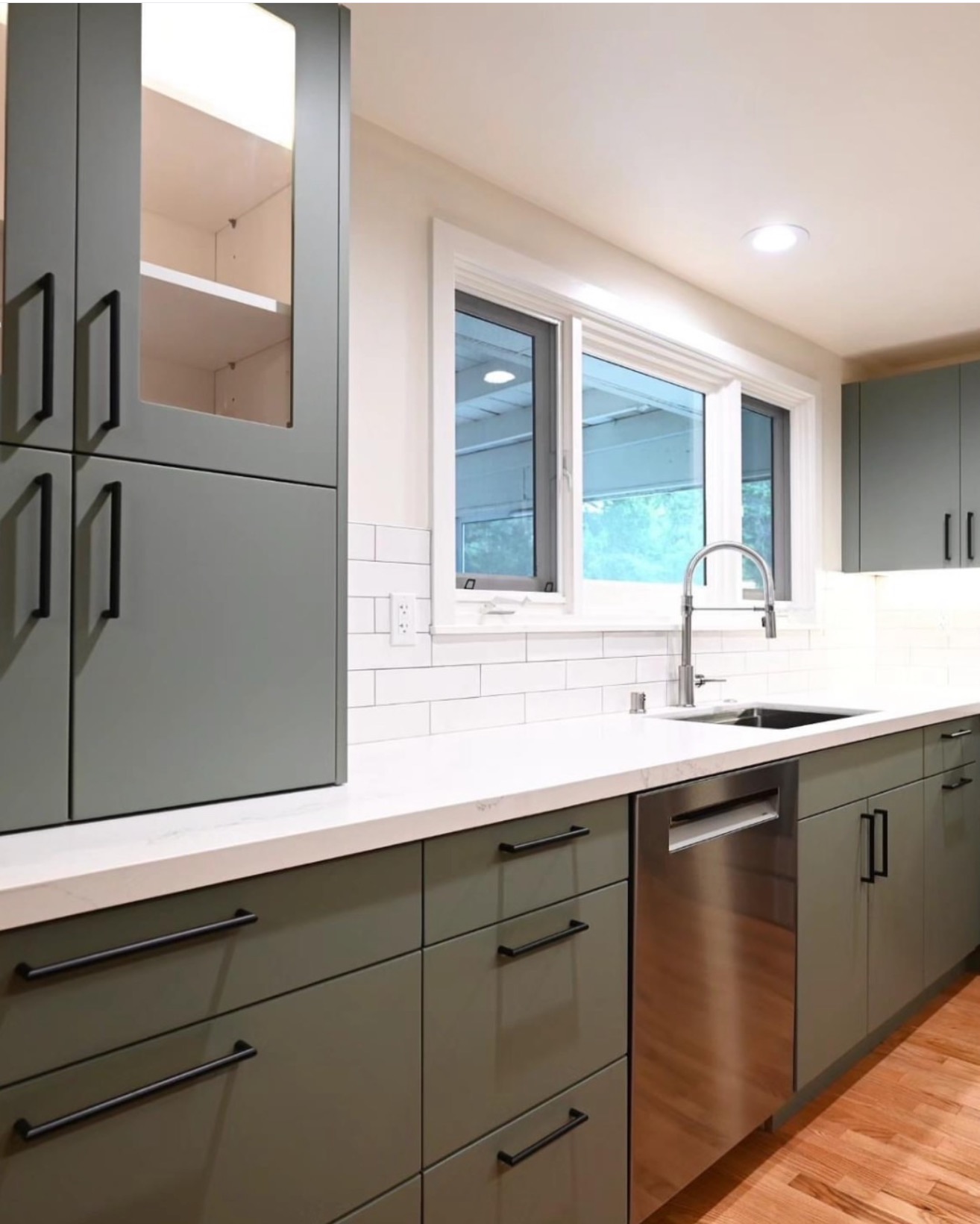 Gray-green kitchen with subway tile and built-in wine fridge — St. Louis remodel by Phoenix Construction Group